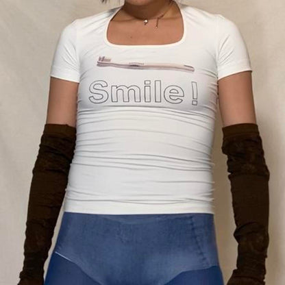 Moschino “Smile” toothbrush graphic fitted compression shirt