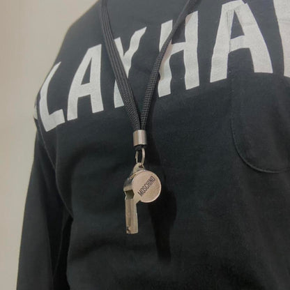 Moschino “Play Hard” longsleeve with working whistle necklace attachment