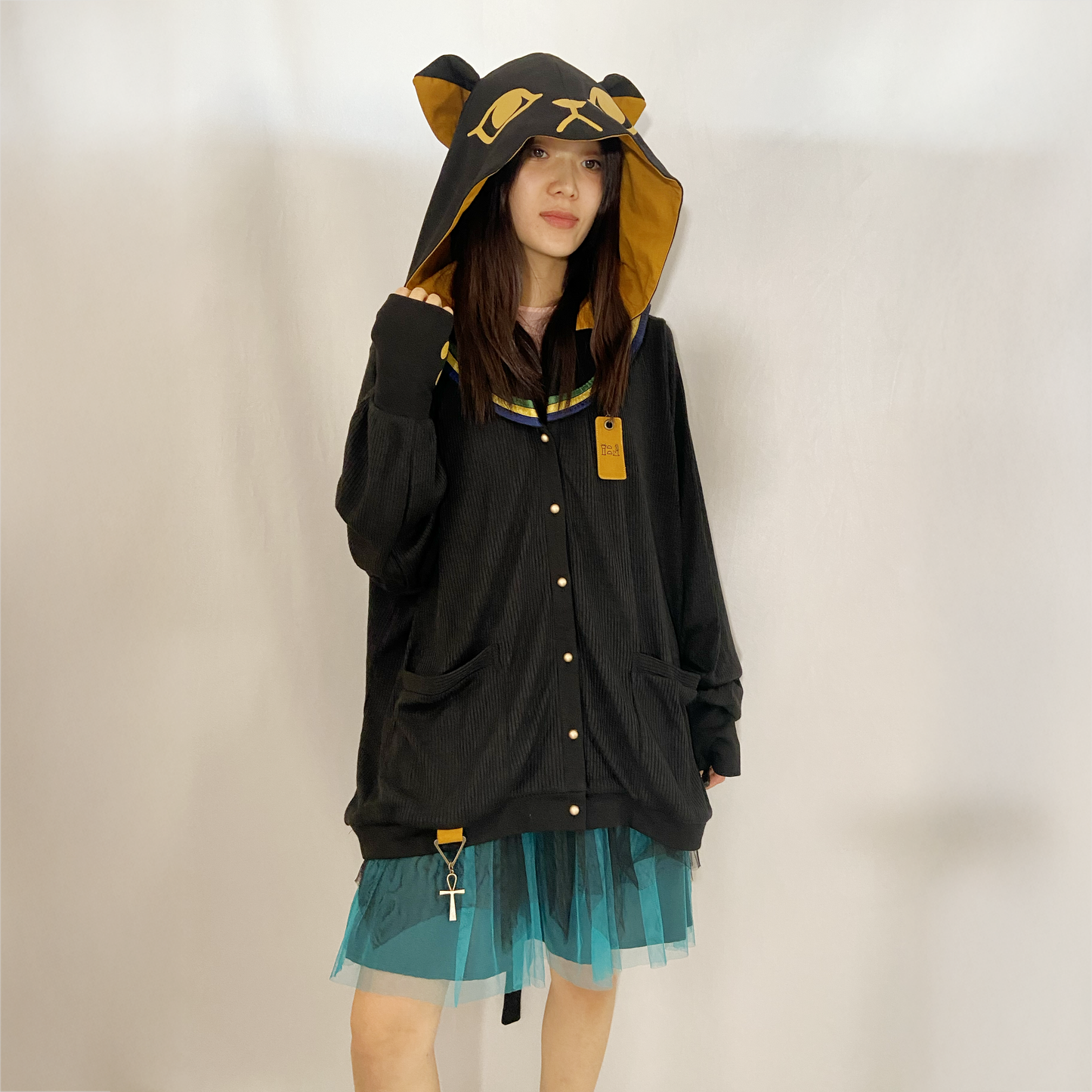 Favorite yellow and black cat hoodie with attached tail and paw print thumbhole sleeve detail